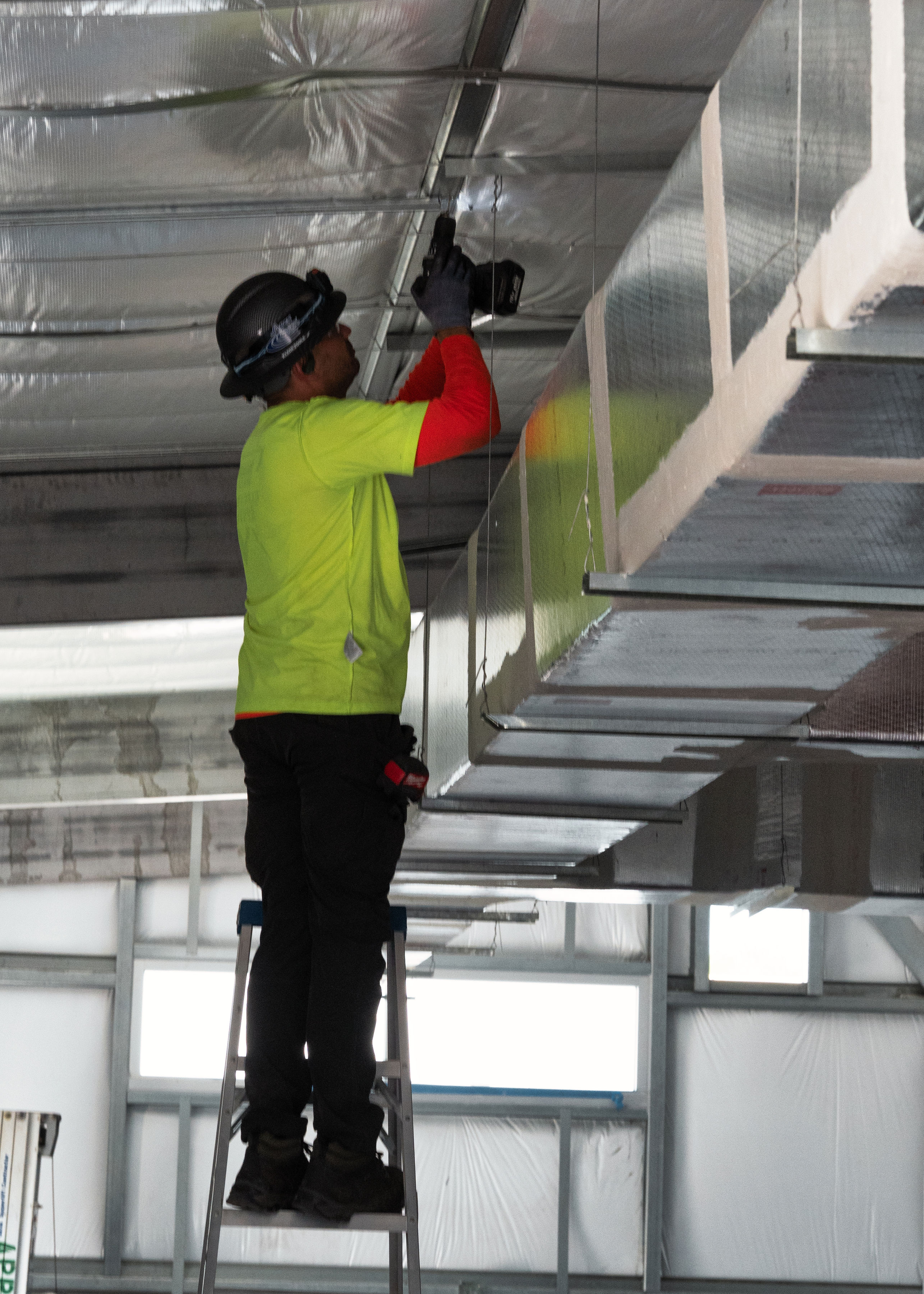 Apex employee working on the new Engineering and shop class building image 4